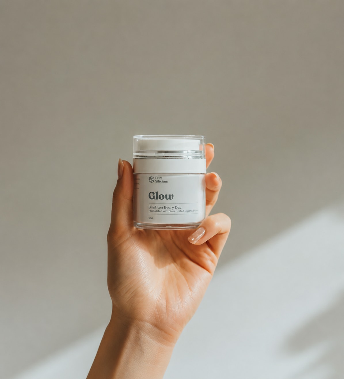 A hand holds a Glow jar in soft daylight